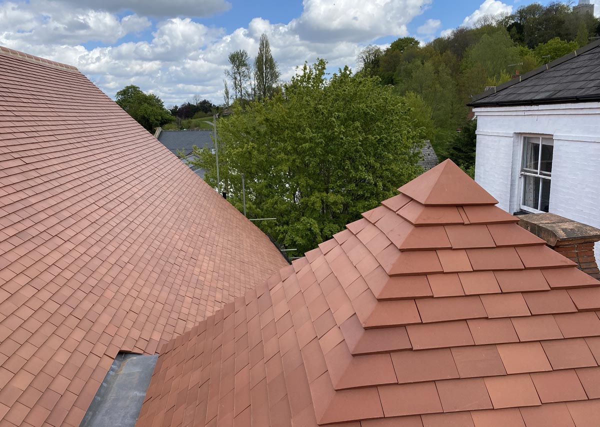 New Dreadnought plum red roof tiles and pyramid roof with end cap.JPEG